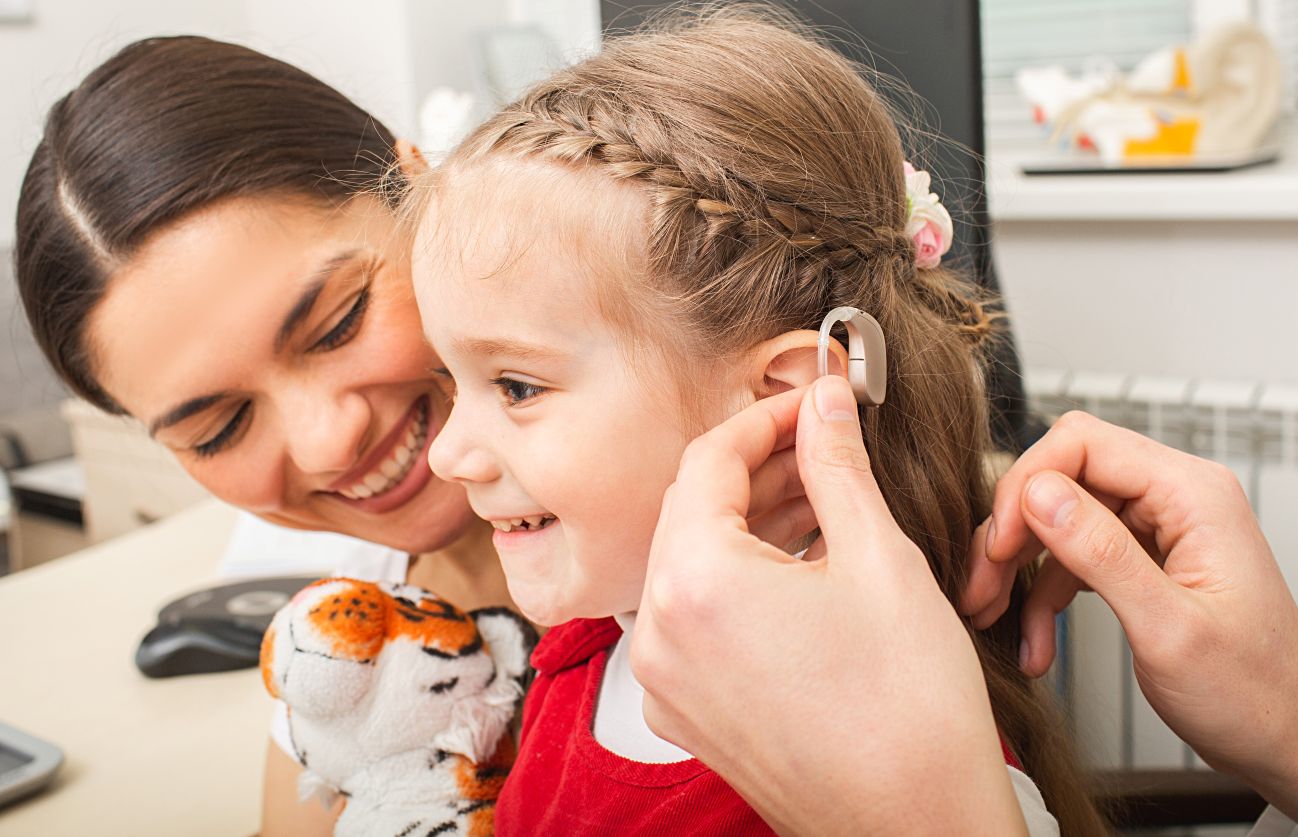 Child wearing pediatric hearing aid child receiving hearing aids